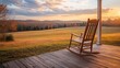 A rocking chair moving slowly on a porch overlooking a calm field