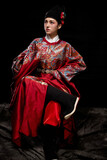 Young woman wearing Ming Dynasty Feiyu clothing on black background