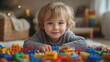 © Diegeme - Young Child Smiling Playfully Among Colorful Blocks in a Bright Room Filled with Joyful Decorations and Soft Lighting Enhancing the Playful Atmosphere