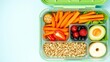 © Chalermrach - A neatly arranged lunch box containing fresh fruits, veggies, and lean proteins, colorful, balanced diet