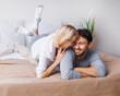 © vgstudio - Portrait image - young adult playful couple lay on bed at bedroom. Beautiful woman, brunette hair man in love, relationship, dating, happy family, comfortable relaxation concept.