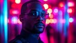 © Linus - A man with glasses is standing in front of a neon sign