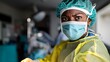© Wilasinee - Experienced surgeon wearing surgical mask and gloves performing a critical medical or procedure in a sterile operating room environment  Concept of advanced healthcare medical expertise