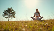 © Elenba - Woman meditating in a field under a clear blue sky