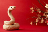 Wooden snake on a red background, chinese new year.