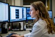 © PD - Healthcare professional analyzing data on multiple computer screens in a modern medical environment