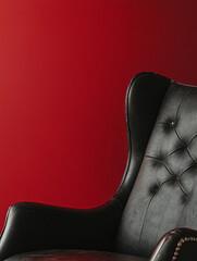 Canvas Print - Black leather armchair against a red backdrop.