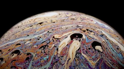 Wall Mural - Closeup video of a soap bubble showing thin film interference concept 