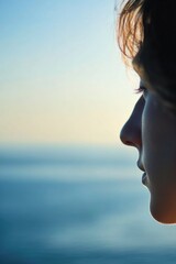 Poster - A person standing near the ocean, gazing out at the waves