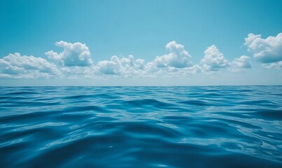 Wall Mural - Calm ocean surface under a blue sky with fluffy white clouds.