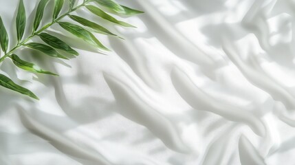 Poster - Soft White Fabric Draped Elegantly With a Green Leaf Detail Creating a Serene Atmosphere for Creative Projects and Stylistic Designs