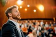 © Lens Legacy - Inspiring speaker engages audience at a vibrant conference in a modern auditorium setting