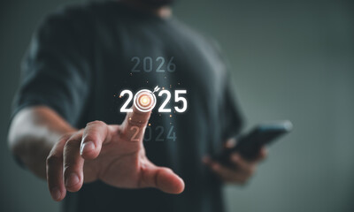 Poster - Positive indicators in 2025, Businessman touching target icon on virtual screen with 2025. Startup business 2025. Merry Christmas and happy new year concept. Idea and inspirations in new years 2025.