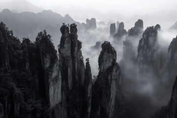 Poster - Misty mountain range with tall rock formations, shrouded in fog, creating a dramatic, ethereal landscape.