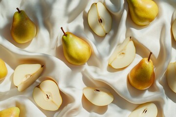 Poster - Yellow pears, whole and sliced, arranged on a creamy fabric background in sunlight.