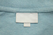 © Kwangmoozaa - White blank laundry care clothes label on shirt fabric background