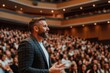 © Papukos - Motivational speaker inspiring audience during conference presentation
