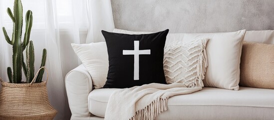 Poster - Creative black and white cross pillow in modern living room with cactus touches enhancing contemporary interior design aesthetics
