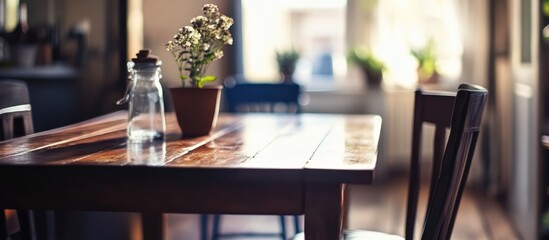 Poster - Chic dining room table with soft focus showcasing modern decor elements and a touch of natural beauty in an inviting atmosphere