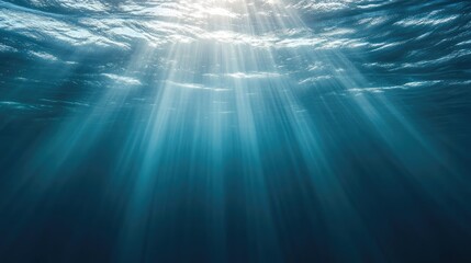 Poster - Blue underwater surface illuminated by sunlight beams creating an ethereal abstract backdrop for creative projects or serene designs