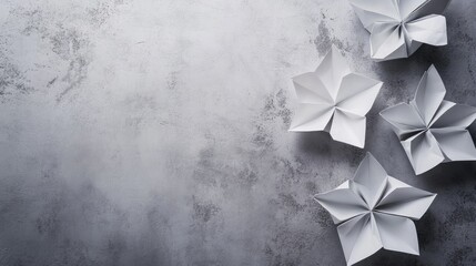 Poster - Elegant gray origami flowers on a textured concrete wall background showcasing creativity and craftsmanship in paper art design.
