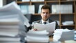 © Vanessa - Concerned Businessman Reviewing Business Regulations at His Cluttered Desk in an Office Environment. Stress, worry, anxiety, deadlines, challenges