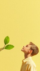 Wall Mural - A young man looking up at a green leaf