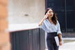 © DG PhotoStock - Asian businesswoman walking on the street in city.