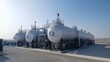 © Badass Prodigy - Massive LPG tanks at a large industrial site, with pipes and gauges visible, under a clear sky