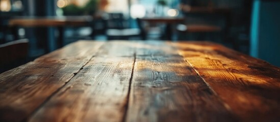 Poster - Rustic wooden table surface with warm lighting and a softly blurred background ideal for dining and interior design inspiration