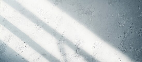 Poster - Interplay of light and shadow on a textured white wall creating a serene and inspiring background for promotional materials or design projects