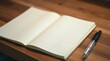 © Kristina - An open notebook lies on a wooden desk, its blank pages inviting creativity and ideas. The notebook features a simple design with a textured cover, and a pen rests beside it, ready for writing.