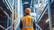 © Raffaza - Worker in hard hat walks in an industrial building.