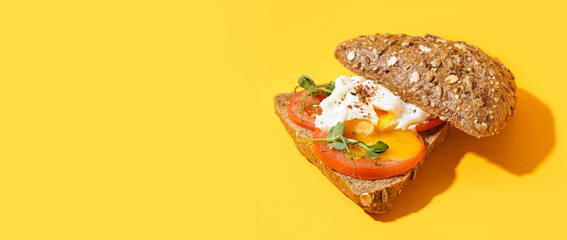 Wall Mural - Tasty sandwich with egg on yellow background