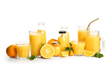 Glasses and bottles of fresh orange juice with mint on white background