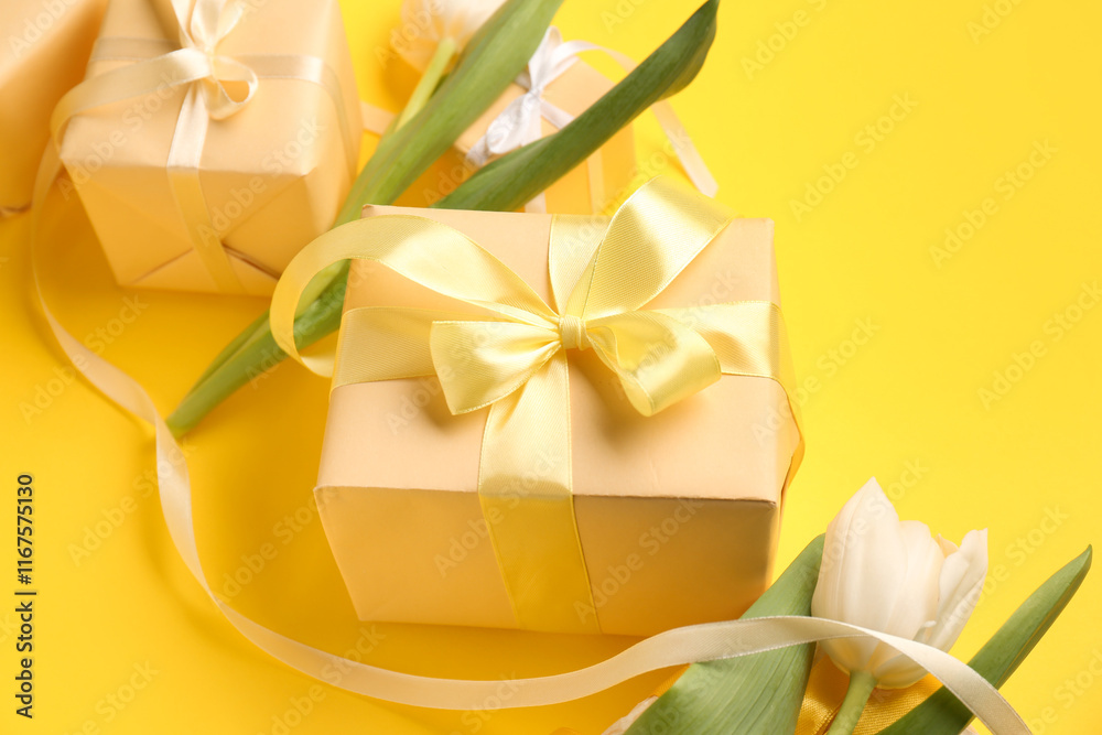 Gift boxes with tulips on yellow background. Happy Women's Day