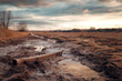 © tynza - Aftermath of a flood with a completely transformed landscape, showing dried mud and ruined infrastructure.
