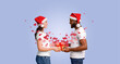 © Prostock-studio - A couple in festive hats exchanges a gift while surrounded by heart-shaped decorations. Their warm smiles and affection highlight the joy of love during a special celebration.