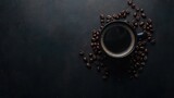 Steaming black coffee and beans on dark background.