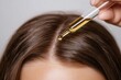 © LifeMedia - Nourishing hair treatment with essential oil application for healthy scalp restoration and shine enhancement