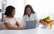 © Prostock-studio - Black women nutritionist and patient looking at laptop screen at clinic, making diet plan, copy space
