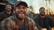 © JoxyAimages - A group of three men laughing together around a table outdoors captures the essence of friendship and joy, sharing a moment of camaraderie in a natural setting.