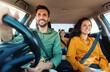 © Prostock-studio - Young european parents and daughter riding new car and smiling, enjoying road trip together. Family having vacation traveling together by auto