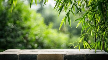 Poster - Stone table with bamboo leaves and blurred green background.
