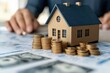 © Dudarte - Sonho em construção: cálculos, maquete e torres de moedas revelam a importância do planejamento financeiro para alcançar objetivos