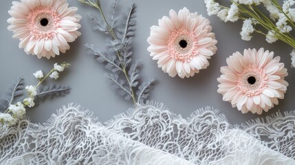 Poster - Flat lay of pink gerbera daisies, white lace fabric, and gray foliage on gray background.