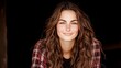 © Pojjanee - Smiling young woman with wavy hair wearing a plaid shirt in natural light portrait style
