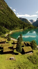 Wall Mural - nestled between towering mountains, traditional grass-roofed homes coexist harmoniously with norways