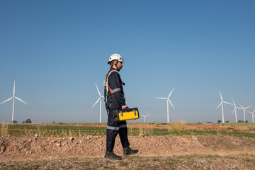Wall Mural - engineer wearing uniform inspection and survey work in wind turbine farms rotation to generate elect