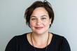 © Duskcraft - Confident smiling woman with short hair against a neutral background portrait